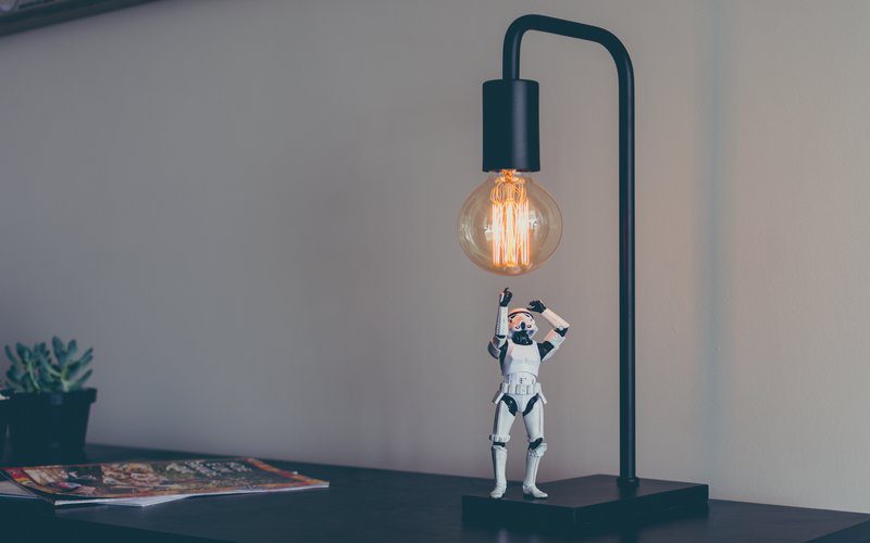 Stormtrooper figurine standing under lightbulb