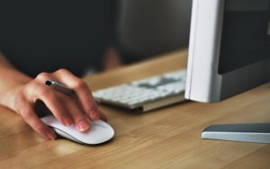 Woman using mouse on computer