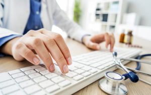 Doctor typing on keyboard
