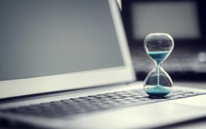 Hourglass on top of laptop keyboard