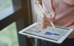 Woman using tablet for analytics and metrics