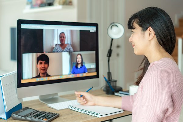 Woman video conferincing for work remotely.