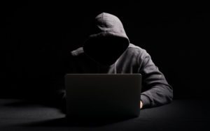 Hacker using a laptop - cybersecurity