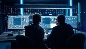 Two security experts reviewing data